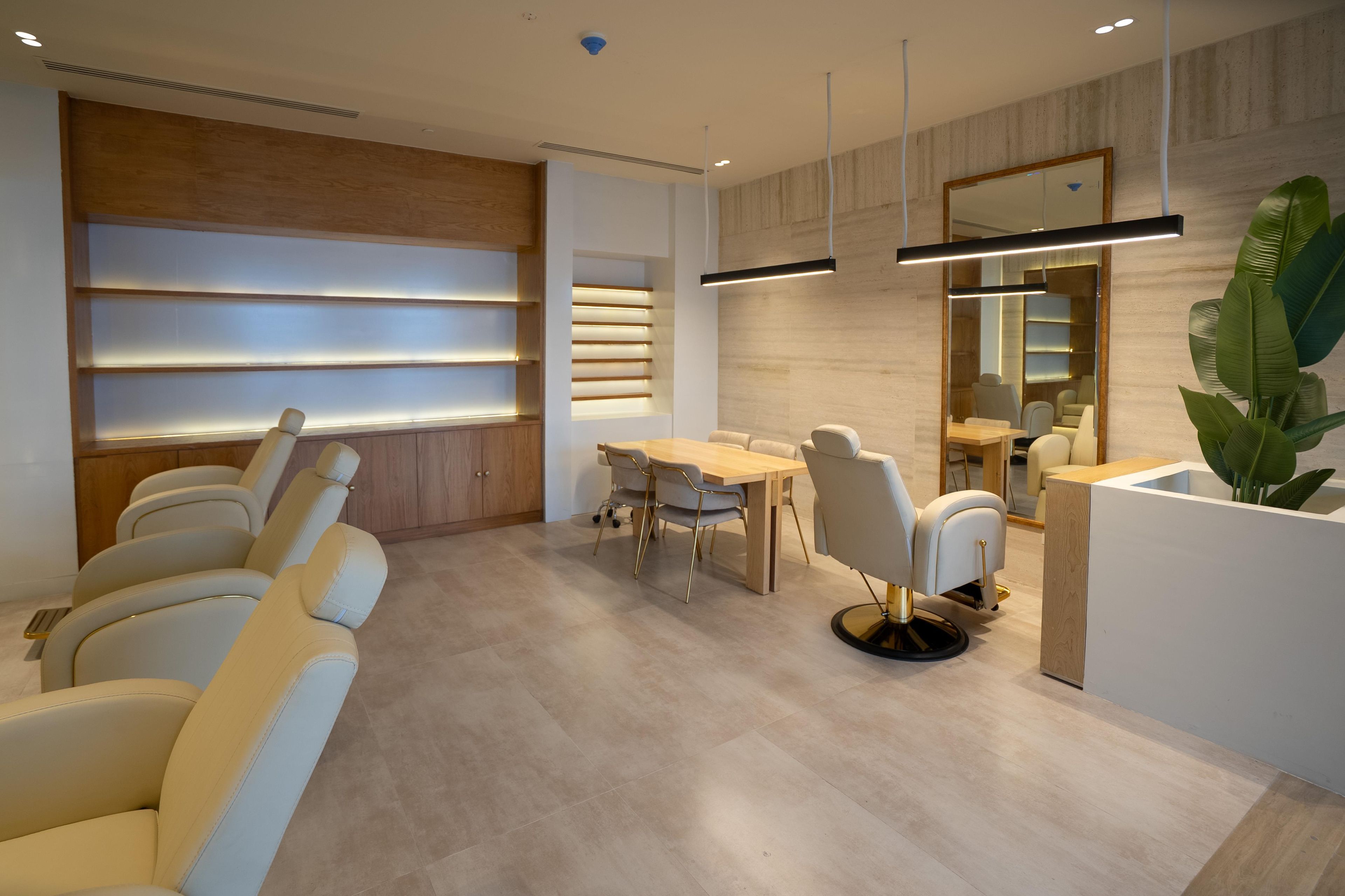 A modern interior with a dining area, seating, and a reception desk.
