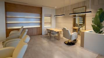 A modern interior with a dining area, seating, and a reception desk.