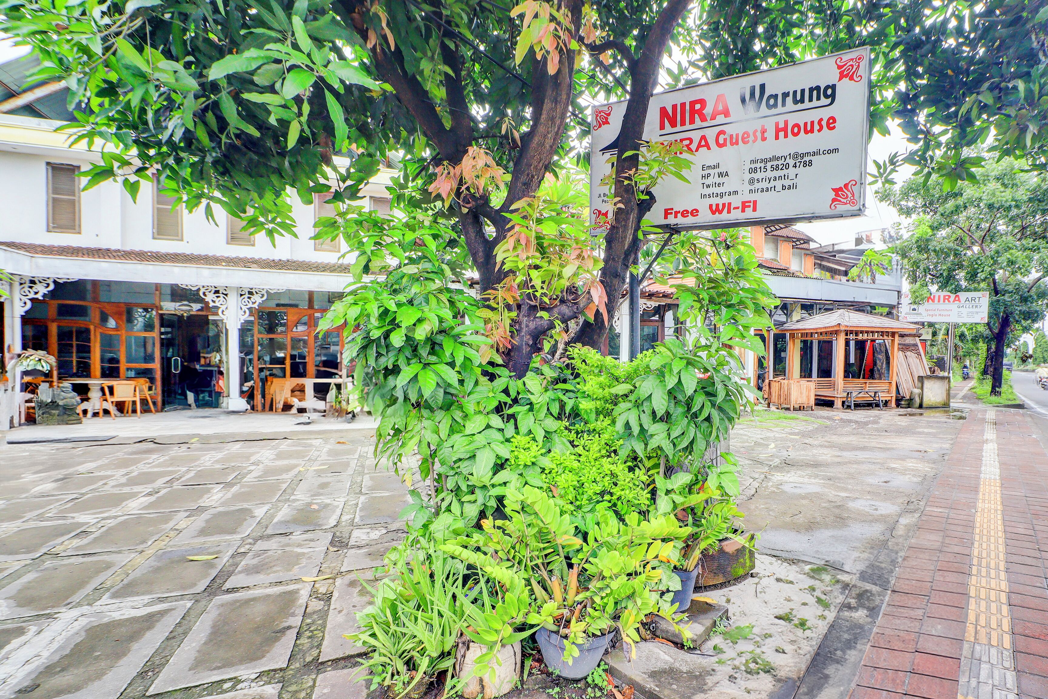 A NIRA Guest House with a signboard advertising free Wi-Fi.