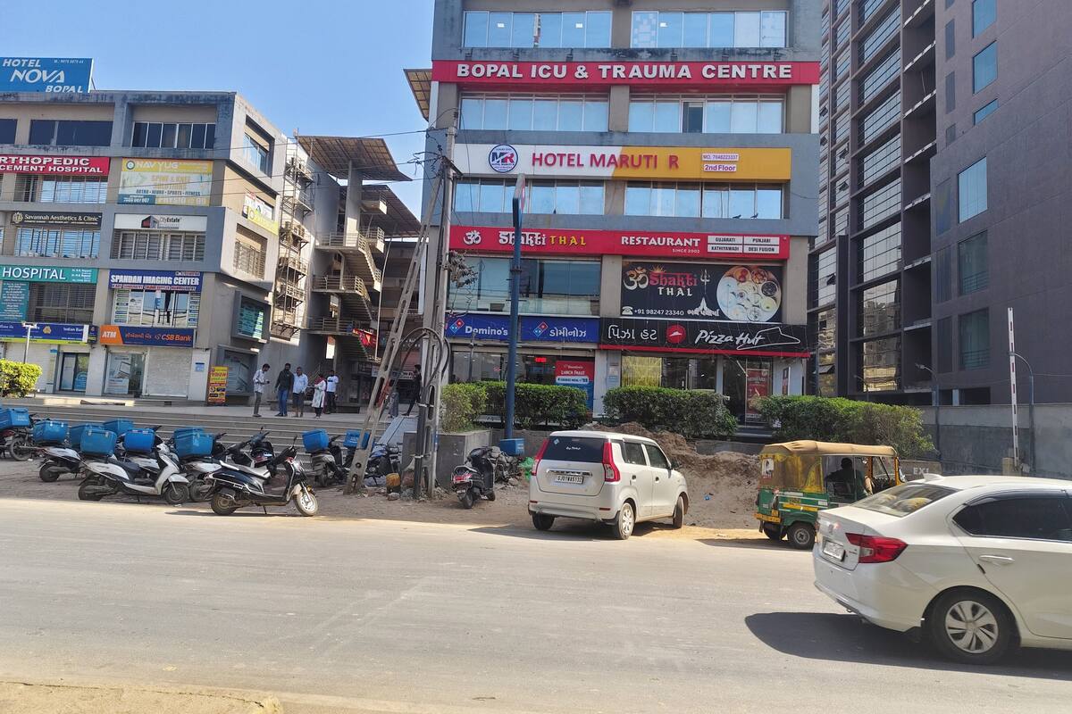 A multi-story building with various businesses including a hospital, a design studio, and a restaurant.