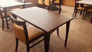 A hotel room with multiple tables and chairs arranged for dining. - Gassan no yado kasiwaya (Nishikawa)
