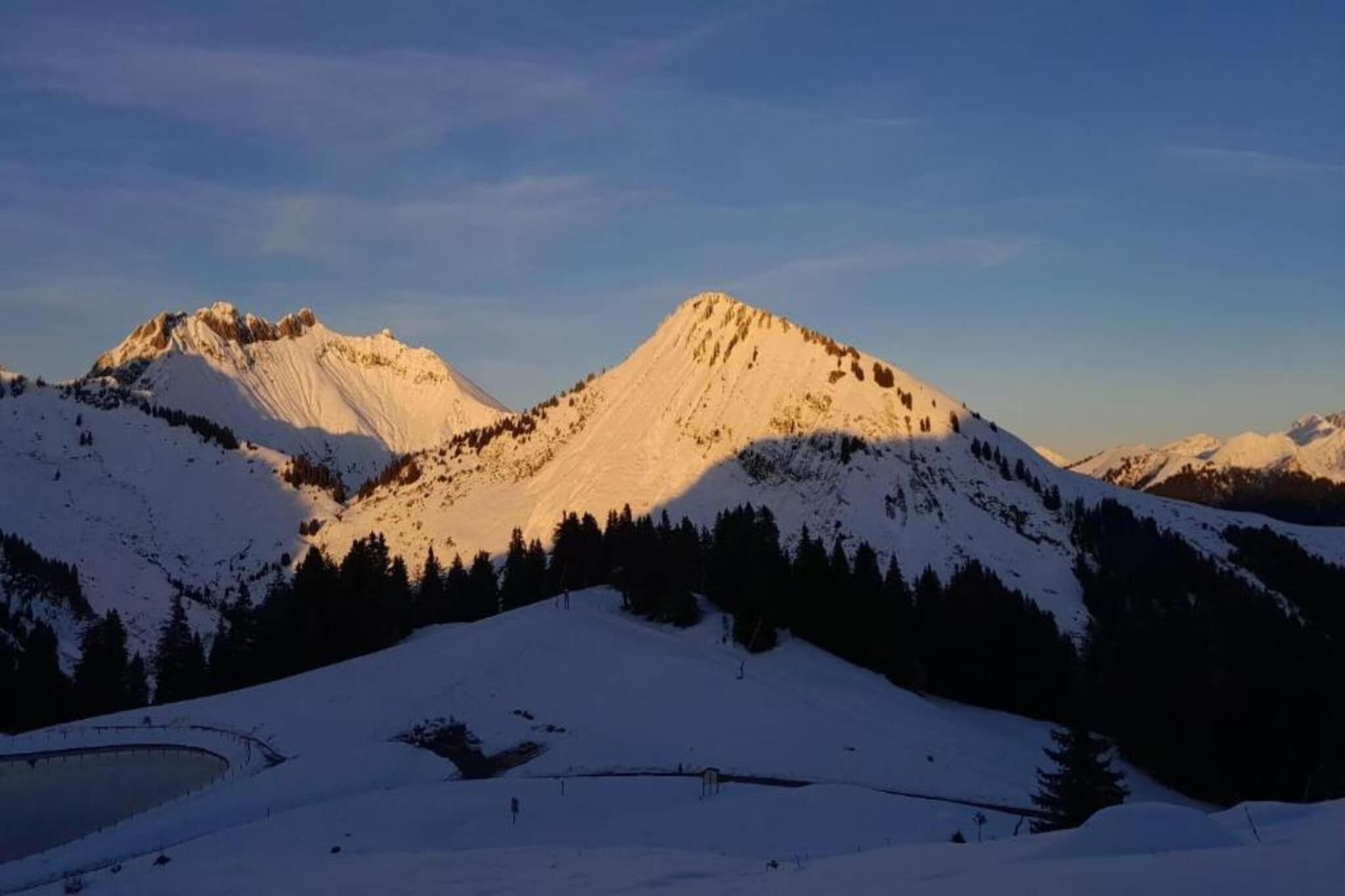 A snow-covered mountain landscape with clear skies.