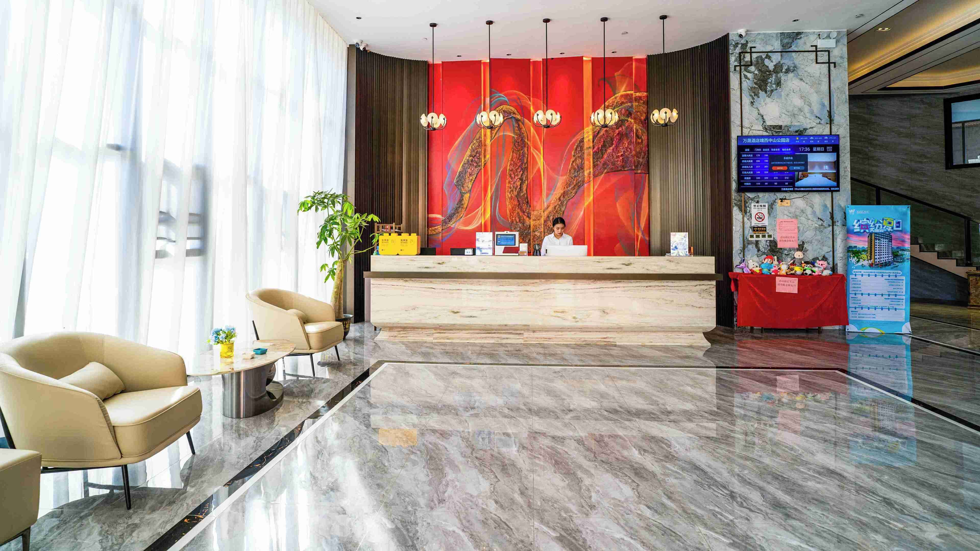 A modern reception area with a marble floor, a reception desk, and a large red mural.