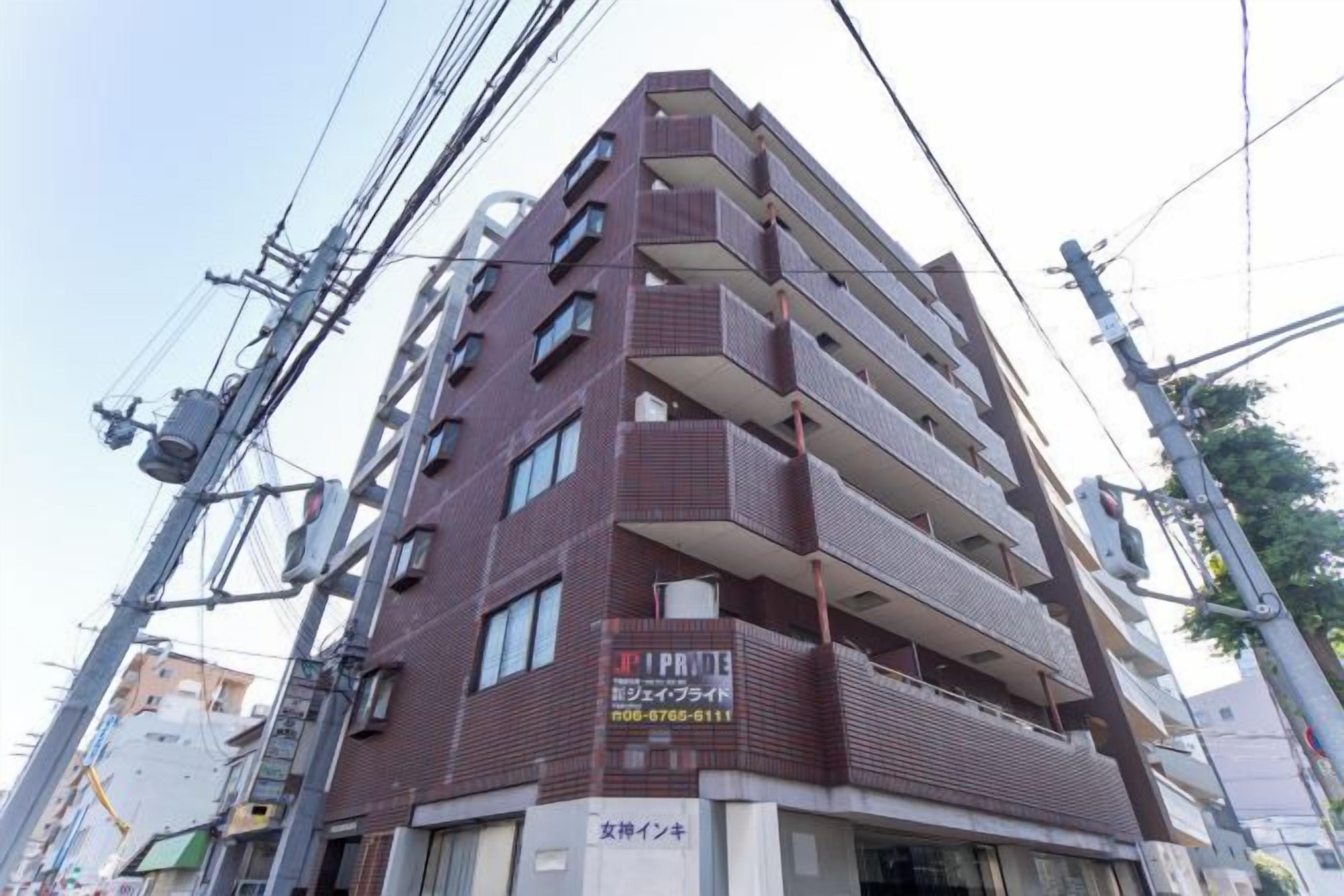 A multi-story building with a commercial sign on the ground floor.