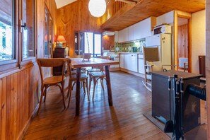 Cozy room with a dining area, kitchenette, and large windows.
