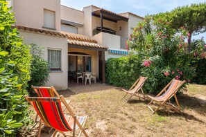 Relax on the balcony or in the garden, surrounded by lush vegetation and comfortable seating.