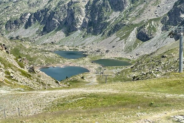 A mountainous landscape with a lake and a ski lift.