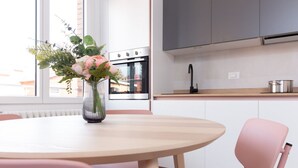 A modern kitchen with white cabinets, a stainless steel oven, and a wooden countertop. - New Exclusive Melegnano Apartments- Near train station X4 (Melegnano)