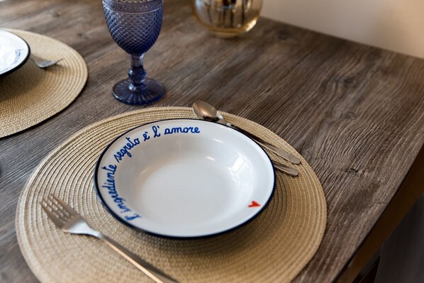 A dining table with a plate, fork, knife, and glass. - Spiga - Exclusive Apartment (Milano)