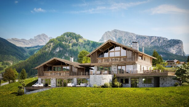 Un chalet à deux étages, doté d’une façade en pierre, de grandes fenêtres et d’un balcon donnant sur une vallée.