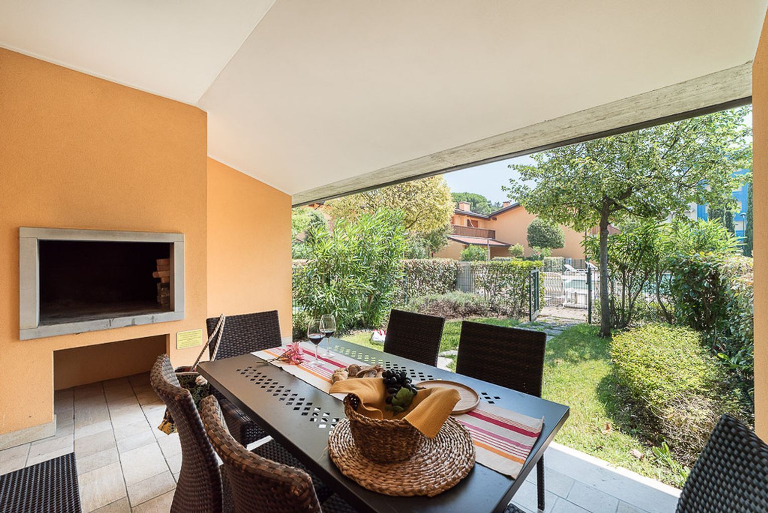 A dining area with a table, chairs, and a television mounted on the wall.