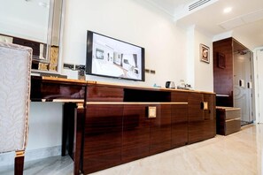 A modern kitchen with a dark wood countertop, a built-in oven, and a large window. - LK Grand Empire (Pattaya)