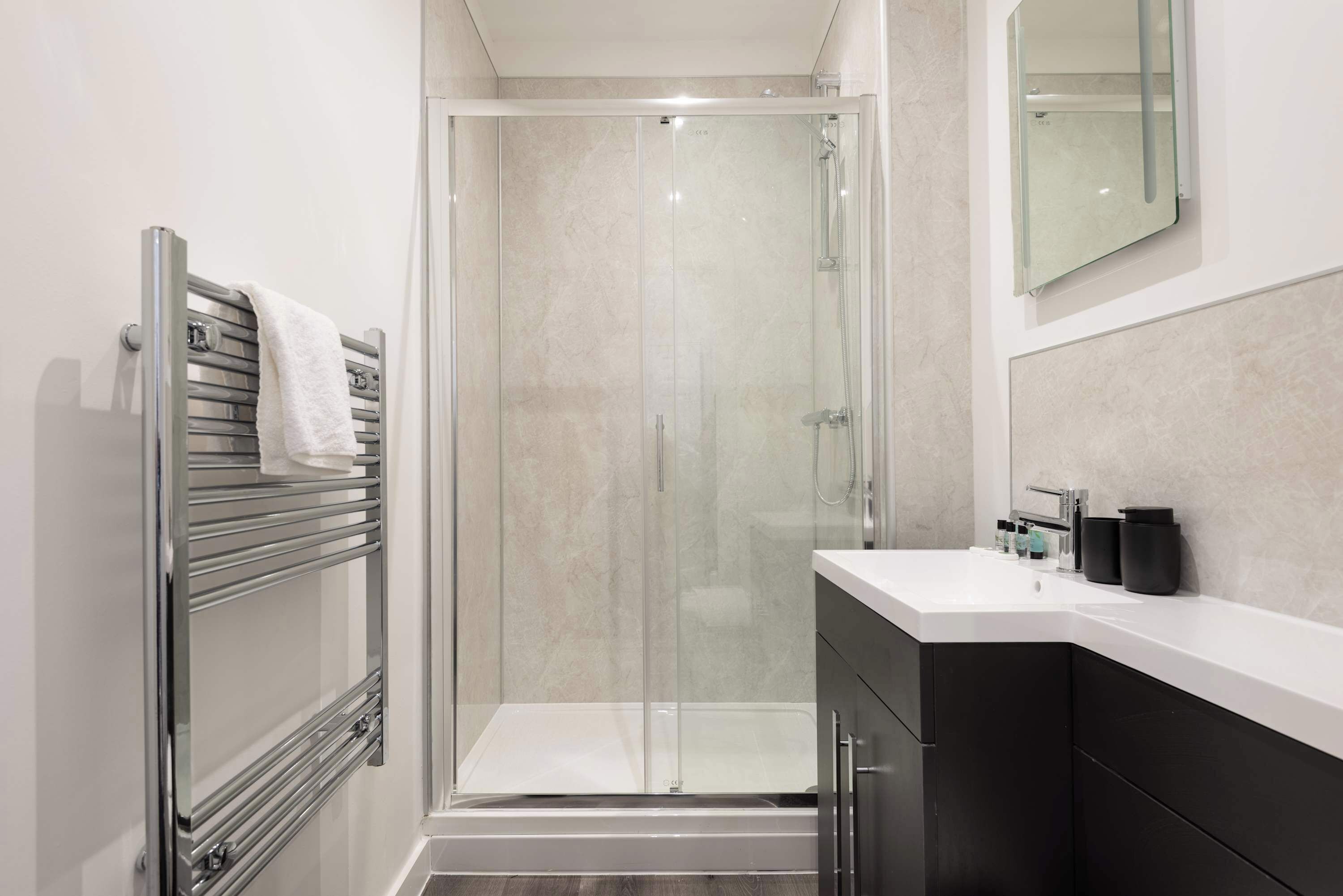 Shower, hair dryer, towels, shampoo
