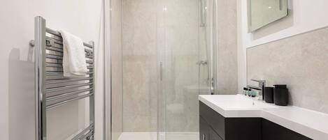 Shower, hair dryer, towels, shampoo