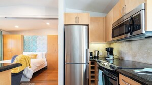 A compact kitchen with a stainless steel refrigerator, a microwave, and a stove. - Perfect Beach Studio:  Full Kitchen, bath, steps from the ocean boardwalk, AC/Heat and parking. (San Diego)