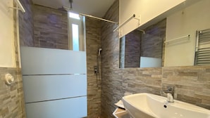 Un baño con ducha, inodoro y lavamanos.