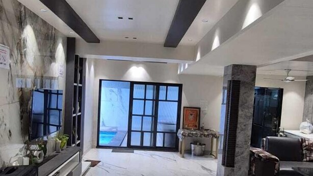 A spacious lobby with a marble floor, a reception desk, and a large window offering a view. - HM Villas (Paud)