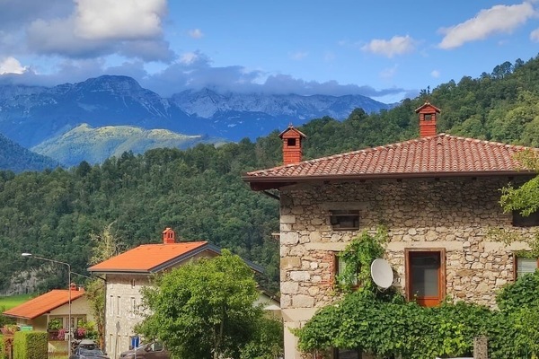 Front of house with Julian Alps behind