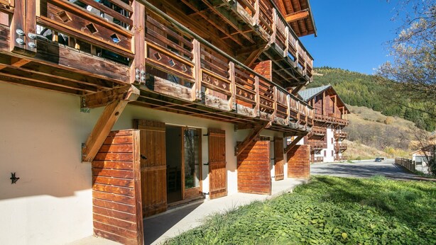 A wooden chalet with balconies, a sloped roof, and a view of a forested hillside. - Les Grizzlis N°20 - 2P5 (Saint-Sorlin-d´Arves)