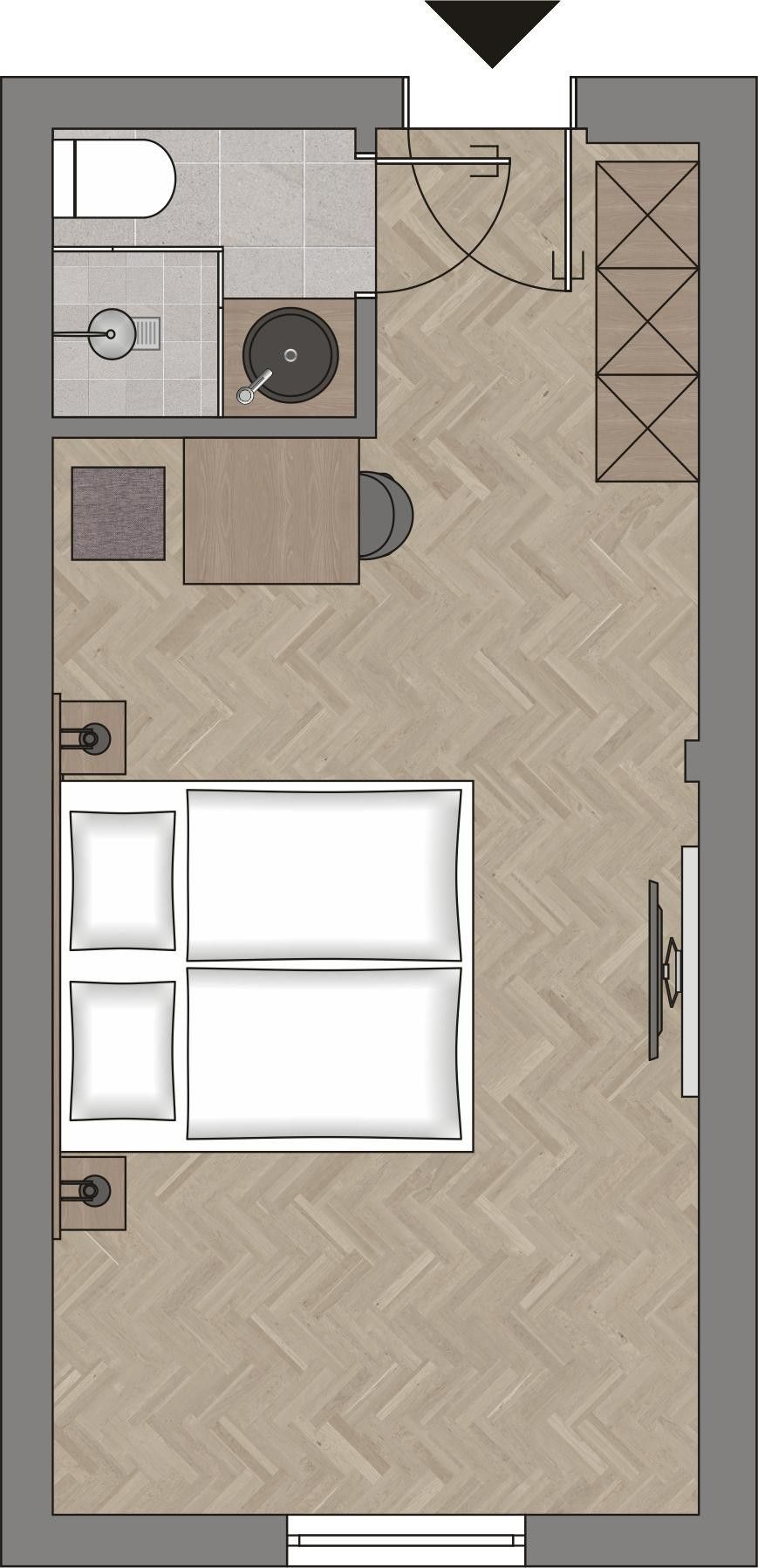 A hotel room layout with a bed, a bathroom, and a small seating area.