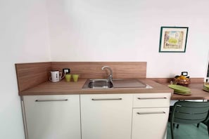A compact kitchenette with a sink, a small countertop, and a single drawer cabinet. - Casa Evelina – Deluxe Room with Private Terrace & Parking (Sant'Agnello)