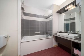 Bathroom features a bathtub, sink, and toilet.