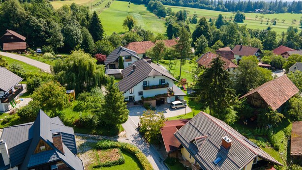 A residential area with houses featuring sloped roofs and a central house with a balcony. - Mountain Nature Apartment with Balcony in Savinja Valley (Mozirje)