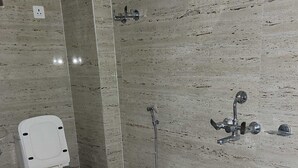 A bathroom with a toilet, a shower, and a sink. - Eastern Heights (Ranchi)
