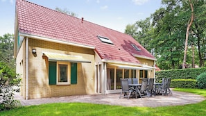 Enjoy a tranquil retreat in this charming home, surrounded by lush greenery and a beautifully manicured lawn.