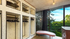 A modern room with a large window, built-in shoe storage, and a bench. - The Planchonella House - Eco Stay de Luxe (Edge Hill)