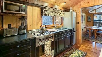 Fridge, coffee/tea maker, cookware/dishes/utensils, dining tables