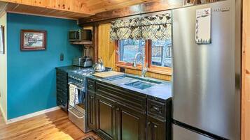 Fridge, coffee/tea maker, cookware/dishes/utensils, dining tables