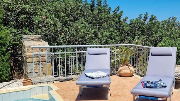 Two sun loungers with towels, a pool, and a stone wall with a metal railing. - Plaka Elounda ..private Pool ..2 Beds..jaccuzi..parking..spinalonga/sea Views (Agios Nikolaos)