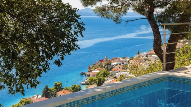 A swimming pool with a clear view of a coastal town and the sea. - Villa Sandra - Private Pool (Pisak)
