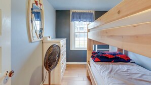 A small, compact room with a bunk bed, a dresser, a mirror, and a window with a view of the outside. - < 1/2 Mi to Beach: Wildwood Getaway w/ Patio! (North Wildwood)