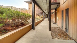 A covered walkway with a concrete path, wooden walls, and a metal roof. - Walk to Lake Chelan: Condo w/ Pool Access (Chelan)