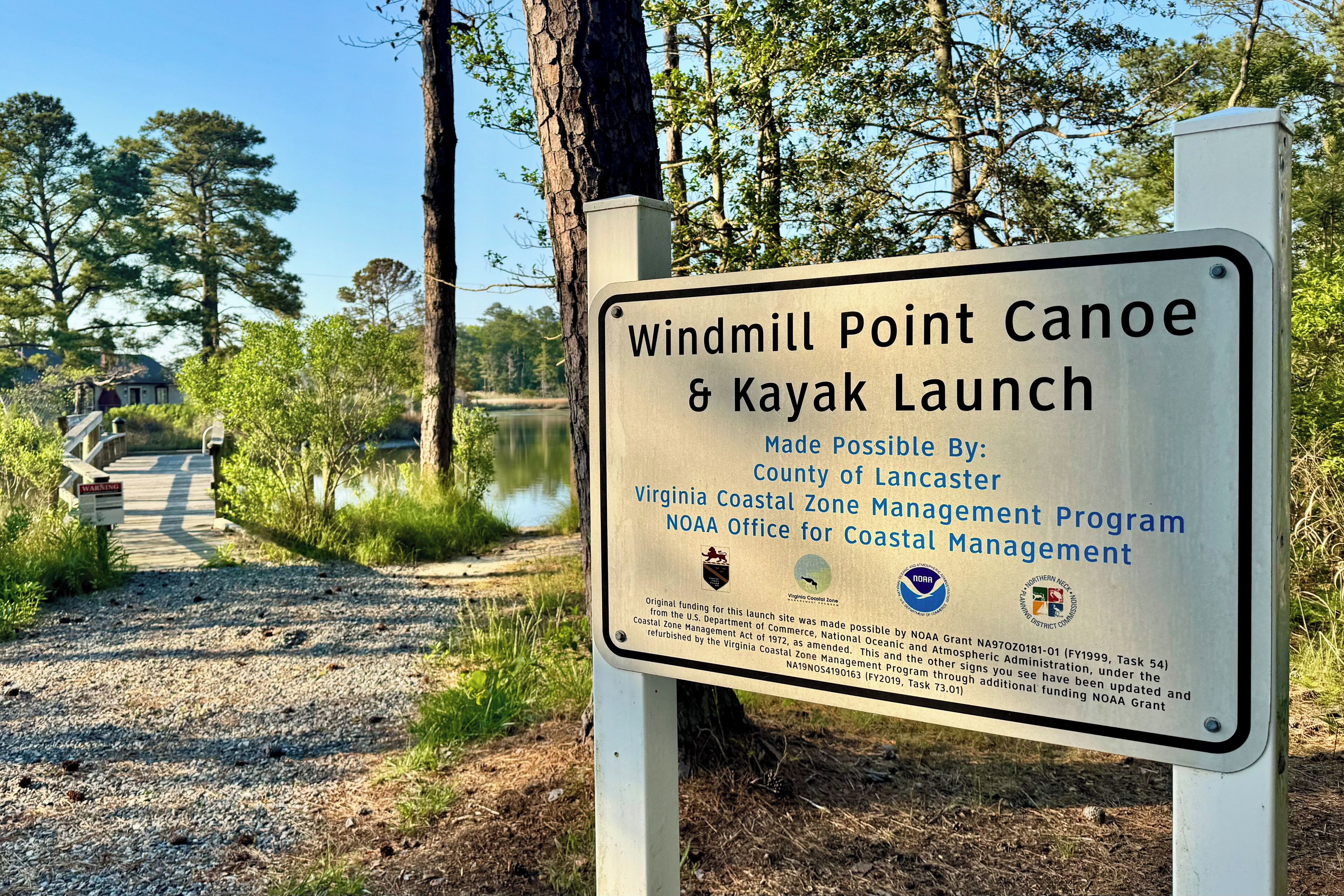 A sign for Windmill Point Canoe & Kayak Launch, made possible by the Virginia Coastal Zone Management Program.