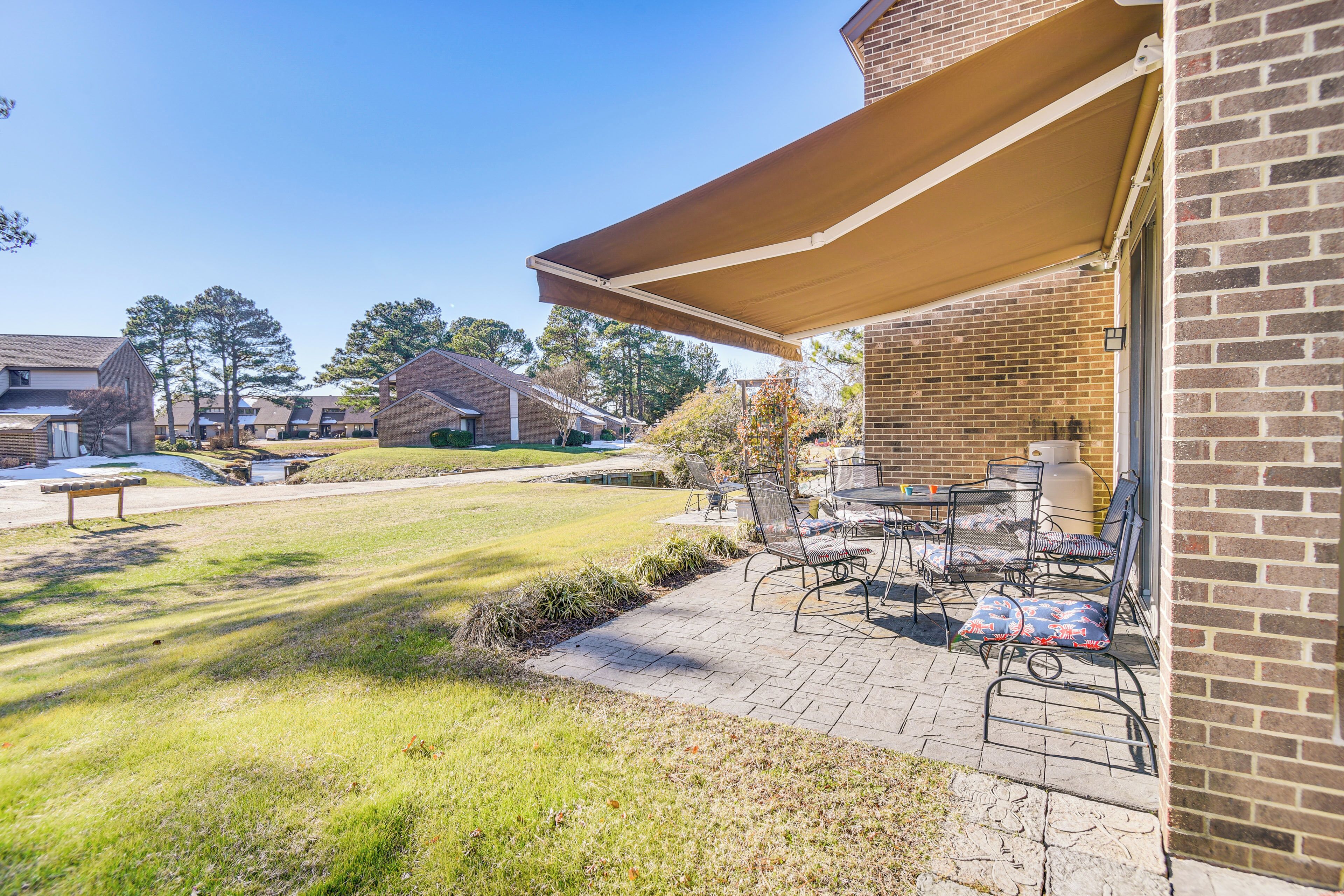 A patio area with outdoor furniture and a covered seating area.
