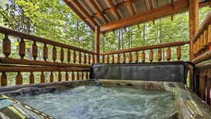 A hot tub with a wooden deck and railing, surrounded by trees. - Private Indoor Pool, Hot Tub, Fire Pit, Pool Table, Free Attractions! (Cosby)