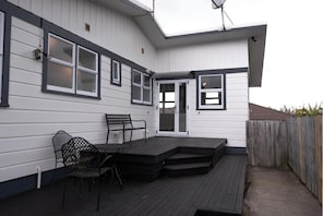 A house with a covered porch, a door, and a window.