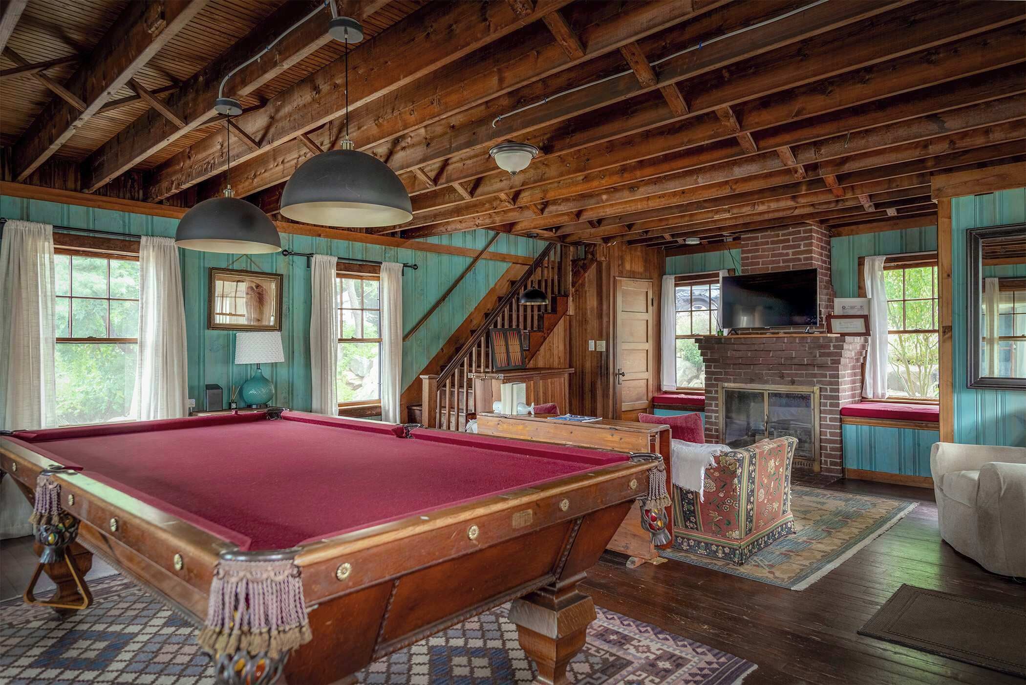 Cozy living room with fireplace (not in use) and exposed beams