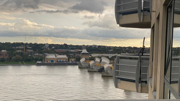 A view from a bridge overlooking a river with industrial buildings and a bridge in the background. - 2 Bed Flat - Sleeps 4 - Parking - Wifi (London)