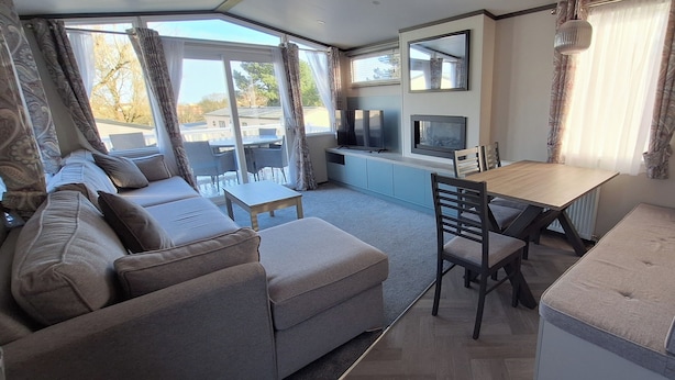 A compact living space with a sofa, a dining table, and a TV.
