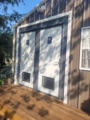 Secure entryway with two restrooms and natural surroundings.