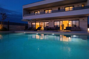 A modern two-story house with a swimming pool, outdoor seating, and large windows. - Villa Freedom (Vodice)
