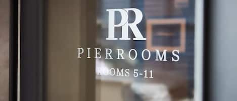 A window with the text "PIERROOMS ROOMS 5-11" indicating the rooms available in this hotel section.