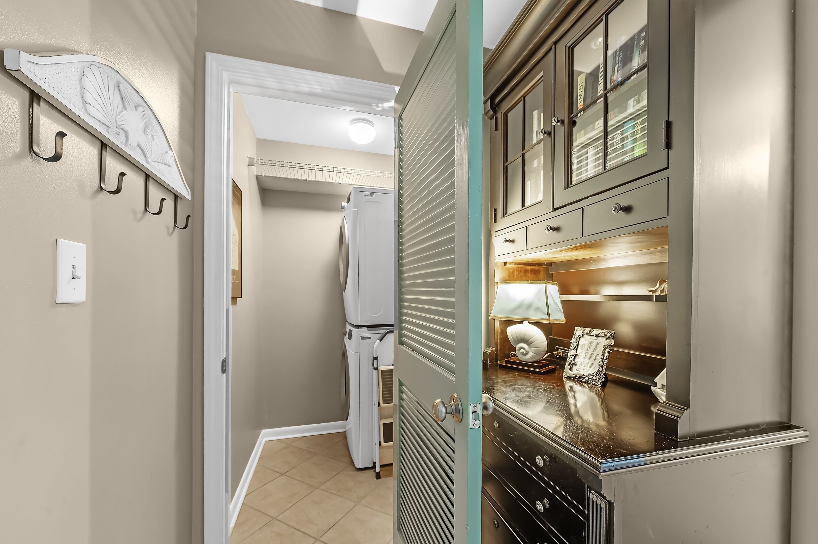 A kitchen with a refrigerator, a sink, and cabinets.