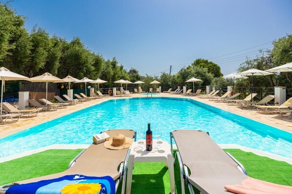 Outdoor pool, open 9:00 AM to 7:00 PM, pool umbrellas, pool loungers