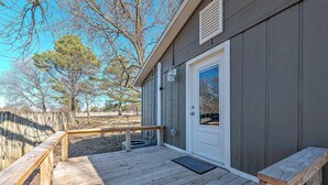 A wooden deck with a bench, a door, and a window. - University Place, family stay, practically on campus (Siloam Springs)