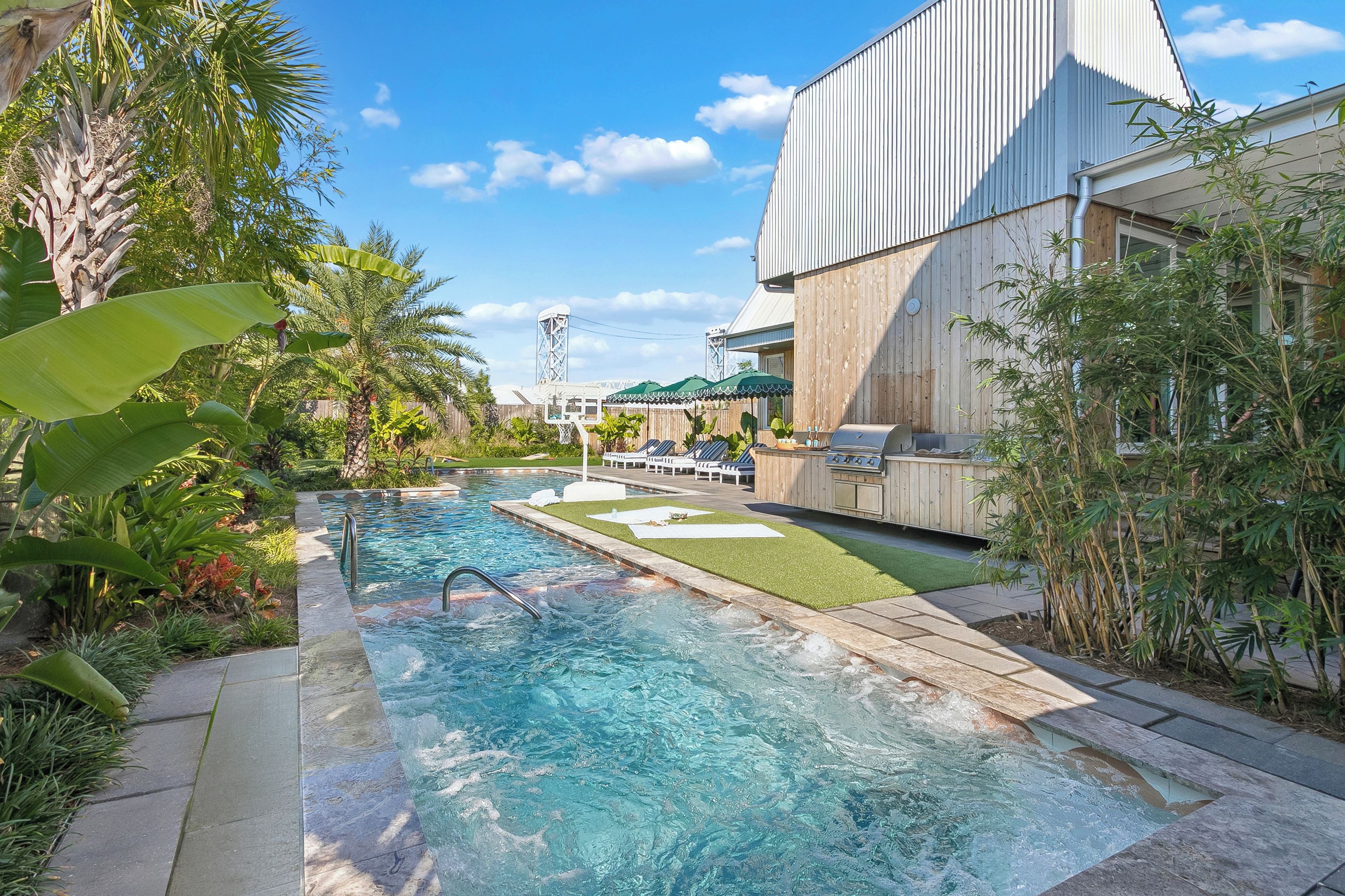 The pool along the side of the villa, with the outdoor kitchen.
